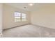 Bright, carpeted bedroom with two large windows offering views of the outdoors at 3578 Tranquility Trl, Castle Rock, CO 80109