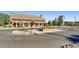 A large community building with barn style doors, a stone facade, and a silo in the distance at 3578 Tranquility Trl, Castle Rock, CO 80109