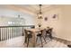 Bright dining room with a modern light fixture, wood table, and an open view to the adjacent room at 3578 Tranquility Trl, Castle Rock, CO 80109
