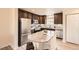 Well-lit kitchen with stainless steel appliances, granite countertops, and dark wood cabinetry at 3578 Tranquility Trl, Castle Rock, CO 80109