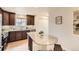 Bright kitchen featuring granite countertops, dark wood cabinetry, and stainless steel appliances at 3578 Tranquility Trl, Castle Rock, CO 80109
