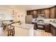 Well-lit kitchen features stainless steel appliances, granite countertops, and dark cabinetry with a center island at 3578 Tranquility Trl, Castle Rock, CO 80109