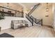 Open-concept living room with stylish furniture and a staircase leading to the upper level at 3578 Tranquility Trl, Castle Rock, CO 80109