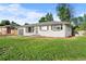 Inviting single-story house with green lawn, attached garage, and classic white exterior paint at 2996 S Sheridan Blvd, Denver, CO 80227