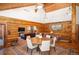 Log home dining room with wood floors, seating for six, views of the mountains, and open access to other living areas at 11652 Camp Eden Rd, Golden, CO 80403