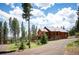 Beautiful log home nestled in the trees with a large deck, perfect for enjoying the outdoors at 11652 Camp Eden Rd, Golden, CO 80403