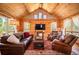 Spacious log home living room with vaulted ceilings, wood floors, comfortable seating, and mountain views at 11652 Camp Eden Rd, Golden, CO 80403