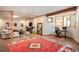 Bright and airy living space with polished concrete floors, a workstation, and a comfortable seating area with a neutral colored sofa at 11652 Camp Eden Rd, Golden, CO 80403