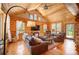 Vaulted-ceiling log home living room with wood floors, comfortable seating, and mountain views at 11652 Camp Eden Rd, Golden, CO 80403