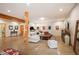 Spacious living room featuring polished concrete floors, a wooden support beam, and a comfortable seating area at 11652 Camp Eden Rd, Golden, CO 80403