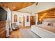 Log home main bedroom with wood floors, white walls, mountain views, and an ensuite bathroom at 11652 Camp Eden Rd, Golden, CO 80403