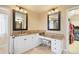 Bathroom features dual sinks, granite countertops, and travertine tile at 851 Swandyke Dr, Castle Rock, CO 80108