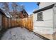Side of the house with a wooden privacy fence and sparse snow-covered ground at 20 1/2 S Sherman St, Denver, CO 80209