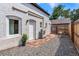 Charming backyard with pea gravel, flagstone path, white painted brick and privacy fence at 20 1/2 S Sherman St, Denver, CO 80209