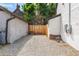 Gravel backyard with a small wood fence and detached building on the property at 20 1/2 S Sherman St, Denver, CO 80209