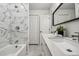 Modern bathroom features a double vanity and a tub-shower combo with stylish tile at 20 1/2 S Sherman St, Denver, CO 80209