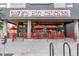 Dave's Hot Chicken restaurant featuring exterior seating with red umbrellas and modern design at 20 1/2 S Sherman St, Denver, CO 80209