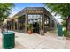 The Postino restaurant building in the city with lots of windows and signage at 20 1/2 S Sherman St, Denver, CO 80209