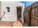 Backyard shed with white painted brick and a wood fence for privacy at 20 1/2 S Sherman St, Denver, CO 80209