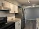 Updated kitchen features granite counters, modern appliances, and sleek cabinets at 7375 E Quincy Ave # 106, Denver, CO 80237