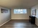 Inviting living room featuring natural light, gray paint, and sleek laminate wood flooring at 7375 E Quincy Ave # 106, Denver, CO 80237