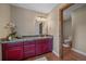 Bathroom with tile floors and counters, rustic vanity with sink, and adjoining toilet room at 4125 Aspen Ln, Evergreen, CO 80439