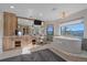 Luxurious bathroom featuring a soaking tub, vanity with storage, and mountain views at 4125 Aspen Ln, Evergreen, CO 80439