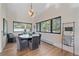 Bright dining room featuring hardwood floors, modern lighting, and large windows at 4125 Aspen Ln, Evergreen, CO 80439