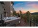 Outdoor hot tub on the deck offers a relaxing experience with a colorful sunset at 4125 Aspen Ln, Evergreen, CO 80439