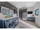 Modern laundry room with sleek gray cabinets, stainless steel appliances, and plenty of storage at 4125 Aspen Ln, Evergreen, CO 80439