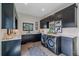 Laundry room features a washer and dryer, dark cabinets, and stylish decor at 4125 Aspen Ln, Evergreen, CO 80439