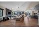 Open-concept living room with fireplace, hardwood floors and mountain views through large windows at 4125 Aspen Ln, Evergreen, CO 80439