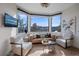 Bright living room with large bay window and comfortable seating offering picturesque mountain views at 4125 Aspen Ln, Evergreen, CO 80439