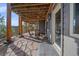 Covered patio area with stone flooring, offering a comfortable outdoor living space at 4125 Aspen Ln, Evergreen, CO 80439