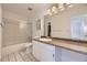 Clean bathroom featuring tiled floors, a shower, and a vanity with ample storage space at 5771 W 92Nd Ave # 335, Westminster, CO 80031
