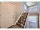 Bright entryway featuring a hardwood staircase, white door, and convenient coat closet at 5771 W 92Nd Ave # 335, Westminster, CO 80031