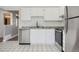 Well-lit kitchen showcasing stainless steel appliances, white cabinets, and subway tile at 5771 W 92Nd Ave # 335, Westminster, CO 80031