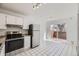 Modern kitchen featuring stainless steel appliances, sleek white cabinets, and backyard access at 5771 W 92Nd Ave # 335, Westminster, CO 80031