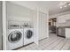 Convenient laundry area featuring front loading washer and dryer and storage with easy access to kitchen at 5771 W 92Nd Ave # 335, Westminster, CO 80031