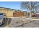 Street view of assigned parking with mature tree and a view of townhomes at 5771 W 92Nd Ave # 335, Westminster, CO 80031