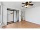 Spacious bedroom with mirrored closet, ceiling fan, and hardwood flooring at 2013 S Helena St # B, Aurora, CO 80013