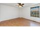This bedroom features wood flooring, a ceiling fan, and a large window at 2013 S Helena St # B, Aurora, CO 80013