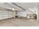 Unfinished garage with concrete floor, white door and exposed beams at 2013 S Helena St # B, Aurora, CO 80013