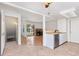 Open-concept kitchen with stainless steel appliances and breakfast bar at 2013 S Helena St # B, Aurora, CO 80013
