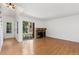Bright living room with a ceiling fan, fireplace, and sliding doors to the outdoor space at 2013 S Helena St # B, Aurora, CO 80013