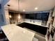 Basement bar with granite countertops, attractive backsplash, wine racks, and pendant lighting at 5506 Malta St, Denver, CO 80249