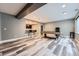 Spacious finished basement boasts bar with seating, pool table, and laminate flooring at 5506 Malta St, Denver, CO 80249