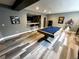 Finished basement featuring a pool table, bar, and modern flooring for entertainment at 5506 Malta St, Denver, CO 80249