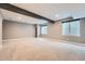 Spacious finished basement with carpeting and neutral paint ready for customization at 5506 Malta St, Denver, CO 80249