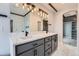 Bathroom featuring dual sinks with modern faucets and a large mirror providing lots of counter space at 5506 Malta St, Denver, CO 80249